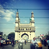 driving past the charminar. hyderabad, india. january 2015.